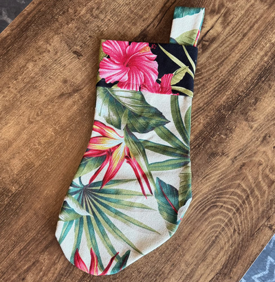 Tropical leaf patterned fabric on a wooden surface